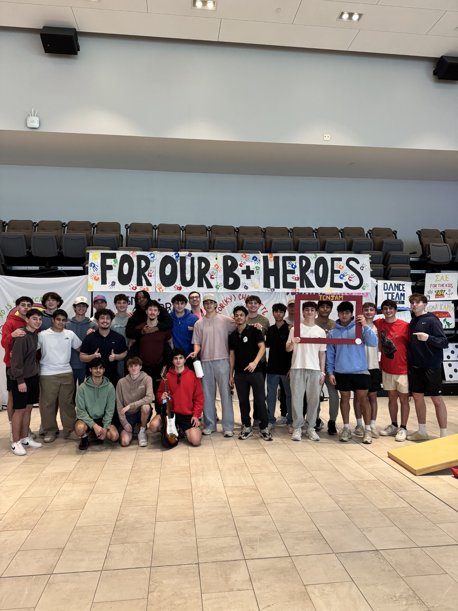 TCNJ SAE gathered beneath the For Our B+ Heroes banner at TCNJam